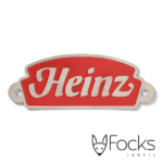 Naamlabel Heinz voor sales promotion, RVS geëtst, achtergrond rood ingelakt, voorzien van 2 boorgaten.